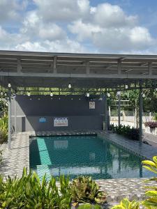 a large swimming pool in the middle of a building at Ilham Penarek Pantai Penarik in Pulau Che Selamah