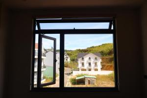 an open window with a view of a house at Prova Home in Da Lat