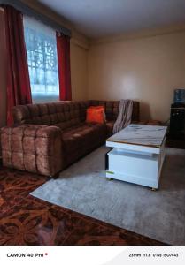 a living room with a couch and a coffee table at Baobab in Webuye
