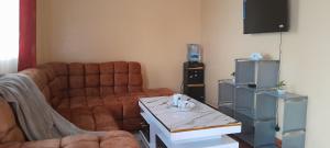 a living room with a couch and a table at Baobab in Webuye