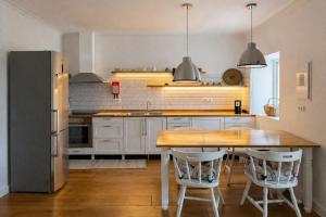 a kitchen with a wooden table and a refrigerator at Pico Sereno in Santana +15 photos