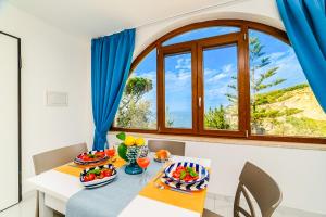 a dining room with a table and a window at Estate4home - Suites Margar in Massa Lubrense