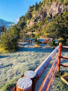a metal fence with a mountain in the background at CABAÑA PARCELA VISTA HERMOSA in Puerto Aisén +51 photos