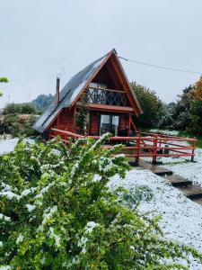 a log cabin with snow on the ground at CABAÑA PARCELA VISTA HERMOSA in Puerto Aisén
