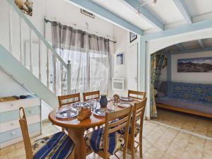 a dining room with a table and chairs at Studio cabine mezzanine 6 pers avec parking privé - FR-1-326-403 in Marseillan