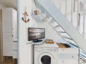 a home office with a computer on a desk next to a staircase at Studio cabine mezzanine 6 pers avec parking privé - FR-1-326-403 in Marseillan