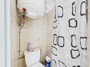 a bathroom with a toilet and a shower curtain at Studio cabine mezzanine 6 pers avec parking privé - FR-1-326-403 in Marseillan +10 photos