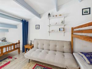 a living room with a couch and a bed at Studio cabine mezzanine 6 pers avec parking privé - FR-1-326-403 in Marseillan