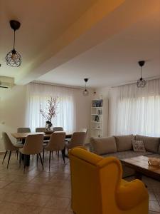 a living room with a couch and a table and chairs at Šumska kuća Juga Kovačević in Bela Crkva