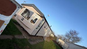 a house that is sitting on the grass at Sunny sands retreat in Skipsea