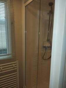 a shower with a glass door in a bathroom at Sunny sands retreat in Skipsea +8 photos