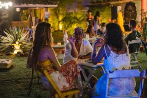 a group of women sitting at tables at an event at Chill House Buzios in Búzios +56 photos