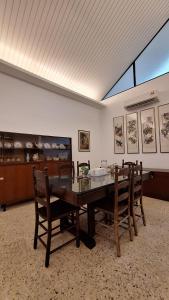 a dining room with a wooden table and chairs at Merdeka House, Bentong in Bentong
