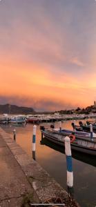 a group of boats docked at a dock at sunset at AR House in Clusane sul Lago