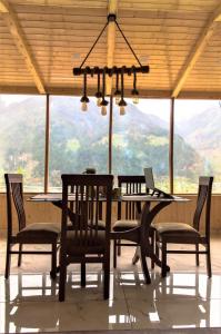 a dining room table with chairs and a laptop on it at Devdar Heights in Jagatsukh +7 photos
