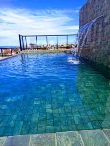 a swimming pool with a water fountain in a building at Villas House - Praia Formosa - Cabedelo in Cabedelo