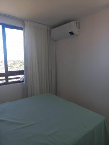 a bedroom with a bed and a window at Villas House - Praia Formosa - Cabedelo in Cabedelo +7 photos