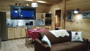 a living room with a couch and a table in a kitchen at Snow in Lamoura +4 photos
