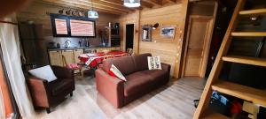 a living room with a couch and a table at Snow in Lamoura