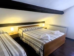 a bedroom with a bed with towels on it at Tino Brezza di Mare in Deiva Marina