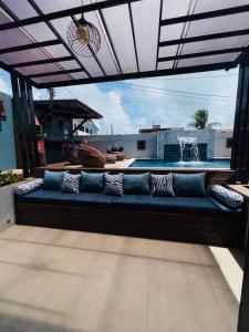 a couch on a patio with a view of a pool at Labonita House - Pilar in Itamaracá
