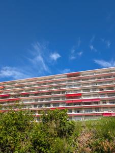 a large building with red windows and a blue sky at Studio in a luxury community in Nice