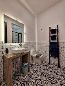 a bathroom with a sink and a toilet and a mirror at Merdeka House, Bentong in Bentong +32 photos