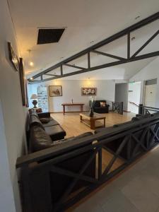 a living room with a leather couch and a table at Soleado Apart Hotel in San Rafael