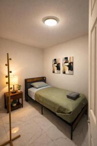 a bedroom with a bed and a table with a lamp at Riio Shores in Miami
