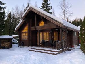 a log cabin in the snow in the woods at Villa Nuttu - Loppusiivous kuuluu hintaan in Jämsä