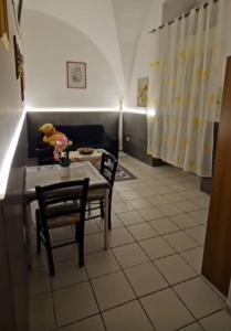 a living room with a table and a couch at Nonna Ninetta - Locazione Turistica in Orta Nova