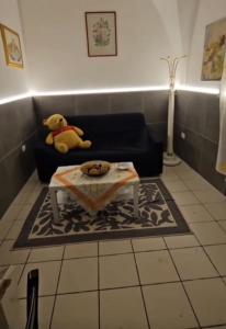 a teddy bear sitting on a couch in a living room at Nonna Ninetta - Locazione Turistica in Orta Nova