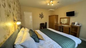 a hotel room with a bed and a desk with a computer at The Coach House in Melbourne