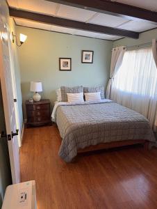 a bedroom with a bed and a wooden floor at Centrally located adu in Eureka