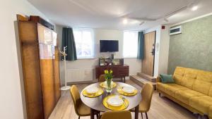a living room with a table and a couch at APARTAMENT Nowoczesny PRL in Bydgoszcz +13 photos