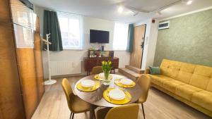 a living room with a table and a couch at APARTAMENT Nowoczesny PRL in Bydgoszcz