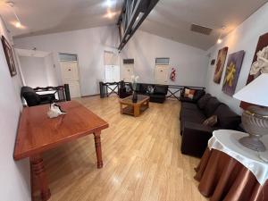 a living room with a couch and a table at Soleado Apart Hotel in San Rafael