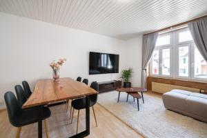 a living room with a table and a couch at Apartment Troya in Unterseen