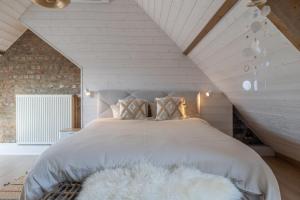 a bedroom with a bed with a white comforter at Warvinge 73 in De Haan