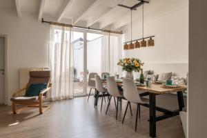 a dining room with a table and chairs at Warvinge 73 in De Haan
