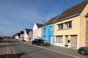 a row of houses on a city street at Warvinge 73 in De Haan