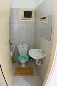 a small bathroom with a toilet and a sink at Cozy Central Nahda in Rabat