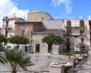 a group of buildings with trees in a courtyard at Al Palmento in Galati Mamertino