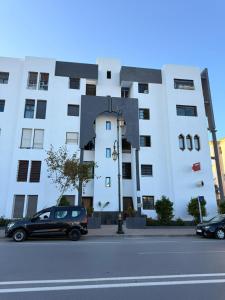 a black car parked in front of a building at Cozy Central Nahda in Rabat +16 photos