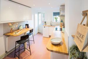 a kitchen with a counter and a table and chairs at Modern Flat on the seafront Exmouth in Exmouth