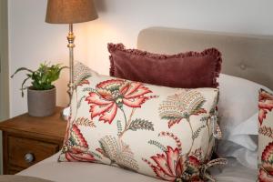 a pillow sitting on top of a bed next to a lamp at Modern Flat on the seafront Exmouth in Exmouth