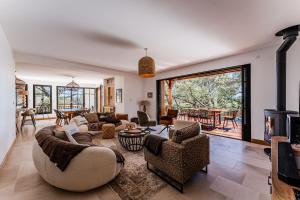 a living room with a couch and chairs and a fireplace at Villa Saint Brice, frontline in Arès