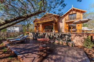 a log home with a deck and a house at Villa Saint Brice, frontline in Arès