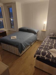 a bedroom with two beds and a window at Cristabel Guest House in Clacton-on-Sea