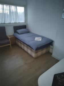 a small bedroom with a bed and a window at Cristabel Guest House in Clacton-on-Sea